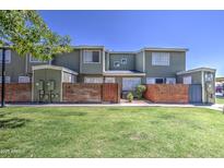 Inviting townhouse featuring a well-manicured lawn and charming brick accents offering a welcoming curb appeal at 2301 E University Dr # 488, Mesa, AZ 85213
