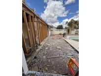 Backyard undergoing renovation, featuring a pool, patio area, and exposed stud framing at 3125 N 82Nd Pl, Scottsdale, AZ 85251