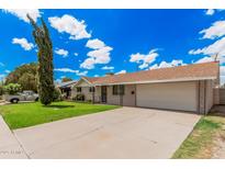 Charming single-level home with a spacious front yard and an attached two-car garage at 3814 W El Camino Dr, Phoenix, AZ 85051