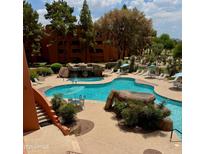 Resort-style pool with waterfalls and lounge seating offers a relaxing outdoor oasis at 4303 E Cactus Rd # 235, Phoenix, AZ 85032