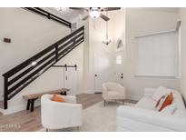 Modern living room with a staircase, barn door, and stylish decor at 7702 W Piute Ave, Glendale, AZ 85308