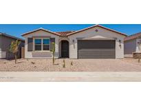 Charming single-story home featuring a two-car garage, desert landscaping, and a neutral color palette at 11408 S 50Th Ln, Laveen, AZ 85339