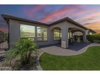 Enjoy outdoor living with this home's covered patio, paved with brick and perfect for entertaining at sunset at 116 E Santa Lucia Ln, Queen Creek, AZ 85140