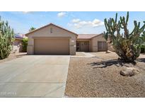 Charming single-story home with a well-manicured desert landscape and a two-car garage at 16222 W Silver Falls Dr, Surprise, AZ 85374
