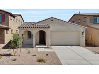 Charming single-story home features a tile roof, stucco facade, and a two-car garage at 16784 W Hope Dr, Surprise, AZ 85388