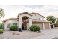 Inviting two-story home featuring a well-manicured yard and a welcoming arched entryway at 19276 N 90Th Pl, Scottsdale, AZ 85255
