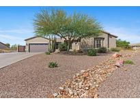 Charming home with desert landscaping, a beautiful Palo Verde tree, and a welcoming walkway at 2239 N Calvin --, Mesa, AZ 85207