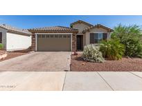 Charming single-story home featuring a brick driveway and a two-car garage at 26753 W Zachary Dr, Buckeye, AZ 85396