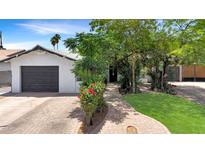 Charming single-story home features a brick driveway and walkway, manicured lawn, and a detached one-car garage at 4639 W Keim Dr, Glendale, AZ 85301