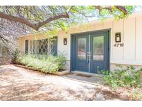 Charming home featuring a blue front door with glass panels and well-manicured landscaping at 4719 N 70Th St, Scottsdale, AZ 85251