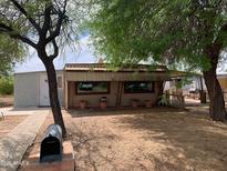 Rustic exterior view with mature trees and a quaint yard, featuring a unique design at 660 S 93Rd St, Mesa, AZ 85208