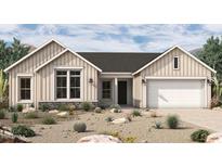 Charming single-story home featuring stone accents and a two-car garage in a well-manicured desert landscape at 953 W Ridge Rd, Apache Junction, AZ 85120