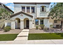 Inviting two-story home featuring a stucco facade, manicured landscaping and covered front porch entry at 10428 E Nopal Ave, Mesa, AZ 85209