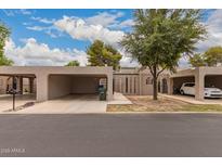 Beige single-story home featuring carports and desert landscaping at 1173 E Cochise Dr, Phoenix, AZ 85020
