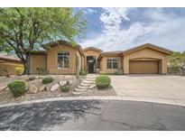 Charming single-story home featuring desert landscaping and a private two-car garage at 12448 N 129Th Pl, Scottsdale, AZ 85259