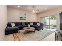 Relaxing living room featuring a comfortable sectional sofa and a sliding door to the backyard at 17205 N 107Th Ave, Sun City, AZ 85373