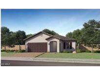 Charming single-story home with a well-maintained lawn and desert landscaping, featuring a two-car garage at 23362 W Atlanta Ave, Buckeye, AZ 85326