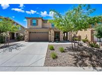 Charming two-story home with a stone-accented facade and a well-manicured front yard at 2387 E Runaway Bay Pl, Gilbert, AZ 85298