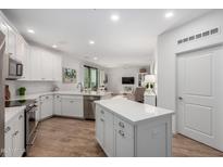 Open-concept kitchen with white cabinetry, stainless steel appliances, and a central island at 2511 W Queen Creek Rd # 174, Chandler, AZ 85248