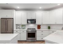 Modern kitchen with white cabinets, stainless steel appliances, and stylish countertops at 2511 W Queen Creek Rd # 174, Chandler, AZ 85248