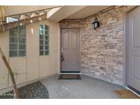 Condo front entrance with stone wall accent and covered entry at 3235 E Camelback Rd # 124, Phoenix, AZ 85018