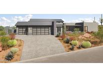Modern home featuring a metal roof, desert landscaping, and a three-car garage at 3911 W Oraibi Dr # 6, Glendale, AZ 85308