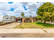 Charming single-story home with a covered carport and inviting curb appeal at 4438 W Hatcher Rd, Glendale, AZ 85302