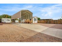 Manufactured home featuring a large carport, wood steps, and low maintenance landscaping at 853 S Evangeline Ave, Mesa, AZ 85208