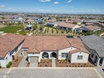 Single-story home with tile roof and desert landscaping in a planned community at 11249 N Blakely St, Surprise, AZ 85388