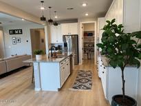 Bright kitchen features white cabinets, granite countertops, stainless steel appliances and a walk-in pantry at 11403 W Ashby Dr, Peoria, AZ 85383
