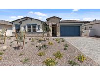 Charming single-story home with desert landscaping, stone accents, and a blue garage door at 12332 W Parkway Ln, Avondale, AZ 85323