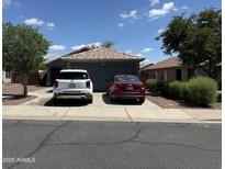 Charming single-story home with a well-maintained front yard and a two-car driveway at 14922 W Port Au Prince Ln, Surprise, AZ 85374