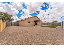 Spacious backyard featuring gravel, a covered patio, and well-maintained block wall fencing at 15120 S Amado Blvd, Arizona City, AZ 85123