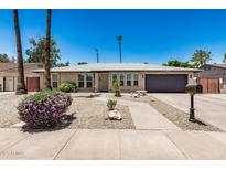 Charming single-story home with well-maintained landscaping and a two-car garage at 2062 S Emerson --, Mesa, AZ 85210