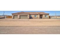 Inviting single-story home featuring a three-car garage and well manicured landscape in a rural setting at 3850 N Mateo Dr, Eloy, AZ 85131