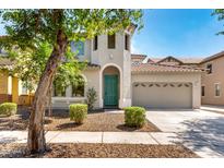 Charming two-story home with a well-manicured yard, neutral stucco, and a two-car garage at 3875 E Claxton Ave, Gilbert, AZ 85297