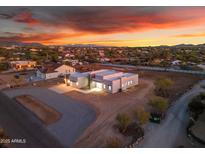 Stunning aerial view of modern home with flat roof at sunset, showcasing the property's layout and neighborhood at 475 W Saddle Mountain Rd, Phoenix, AZ 85086