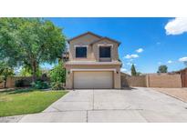 Charming two-story home with a well-manicured lawn and inviting curb appeal on a sunny day at 5787 W Barbara Ave, Glendale, AZ 85302