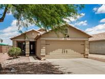 Charming single-story home with a two-car garage and desert landscaping at 6638 W Nez Perce St, Phoenix, AZ 85043