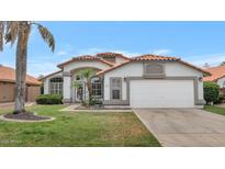 Charming single-Gathering home with a well-maintained lawn and a classic white exterior in a serene neighborhood at 6915 E Lakeview Ave, Mesa, AZ 85209