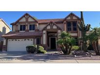 Charming two-story home with a two-car garage and desert landscaping at 6928 W Oraibi Dr, Glendale, AZ 85308