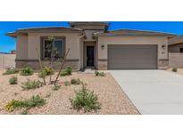 Charming single-story home with desert landscaping, gray trim, and a two-car garage at 6952 E Brushy Bill Rd, San Tan Valley, AZ 85143
