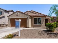 Charming single-story home with a tile roof, two-car garage, and low maintenance desert landscaping at 7086 W Spur Dr, Peoria, AZ 85383