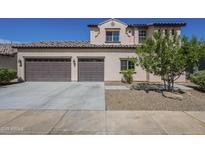 Beige two-story house with a two-car garage and tile roof at 8518 S 8Th Ln, Phoenix, AZ 85041