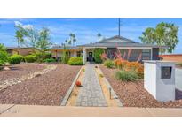 Charming home with desert landscaping, brick walkway and fresh exterior paint at 8730 E Montecito Ave, Scottsdale, AZ 85251
