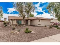 Charming single-story home with desert landscaping and mature shade tree at 9265 E Kalil Dr, Scottsdale, AZ 85260