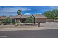 Charming single-story home with a two-car garage and low-maintenance desert landscaping at 9476 E Laurel Ln, Scottsdale, AZ 85260