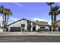 Charming single-story home with a tile roof, manicured landscaping, and a two-car garage at 1441 W Sea Haze Dr, Gilbert, AZ 85233