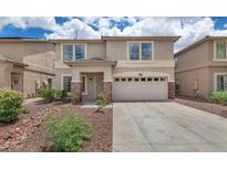 Charming home featuring a two-car garage and desert landscaping for low maintenance living at 1821 E Patrick Ln, Phoenix, AZ 85024
