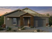 Charming single-story home features a stylish brick facade and a two-car garage at 20747 E Arroyo Verde Dr, Queen Creek, AZ 85142